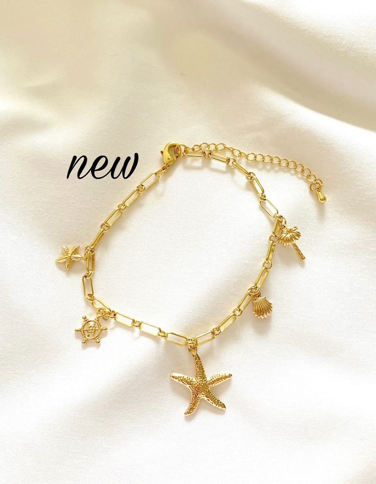 "Anklets are a summer must have and the cute beachy charms on this anklet make this one a NEED! Anklet features 5 gold charms: two starfish, a shell, a palm tree and a helm. Anklet is 8 inches long and comes with a 2\" chain extender - 10\" is the max length. If another size is desired send me a message, I can usually accommodate!  Please note this anklet is not meant to be worn in water and doing so may result in changes to the metal's colour." Gold Starfish Jewelry For Vacation, Gold Star Charm Jewelry For Vacation, Gold Jewelry With Star Charm For Vacation, Beachy Gold Jewelry With Starfish Charm, Gold Starfish Charm Jewelry For Beach, Gold Jewelry With Starfish Charm For Beach, Gold Beach Jewelry With Starfish Charm, Gold Bracelet With Adjustable Chain For Beach, Dainty Gold Bracelets For Beach