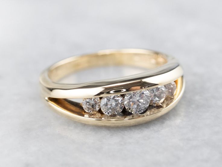 a three stone diamond ring sitting on top of a table