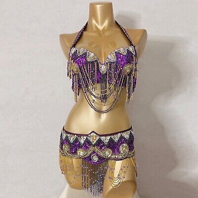 a gold and purple belly dance costume on a mannequin