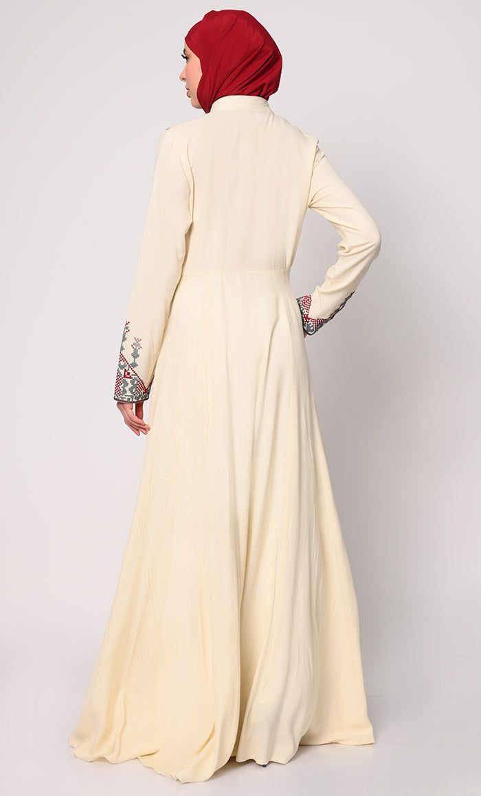 Discover the perfect fusion of elegance and practicality with our Women's Abaya, meticulously crafted to elevate your wardrobe. Featuring modern cross stitch embroidery on the bodice, this abaya exudes sophistication and timeless charm. The addition of two discreet pockets ensures functionality without compromising on style, providing ample space to keep essentials close at hand. Designed for effortless sophistication, a hidden button placket maintains a clean, streamlined front, while waist gathers create a graceful drape that enhances the figure beautifully. A refined stand collar completes the look with understated elegance, framing the face with finesse. Crafted from premium fabric, this abaya promises luxurious comfort and versatility, making it an essential piece for both formal occa Embroidered Long Sleeve Maxi Dress, Embroidered Long Sleeve Maxi Dress For Eid, Long Embroidered Dress With Floral Embroidery For Eid, Elegant Abaya With Chikankari Embroidery For Eid, Long Sleeve Maxi Dress With Dabka Work For Eid, Long Floral Embroidered Dress For Eid, Modest Embroidered Maxi Dress For Eid, Eid Abaya With Floral Embroidery And Long Sleeves, Embroidered Long Sleeve Kaftan For Wedding