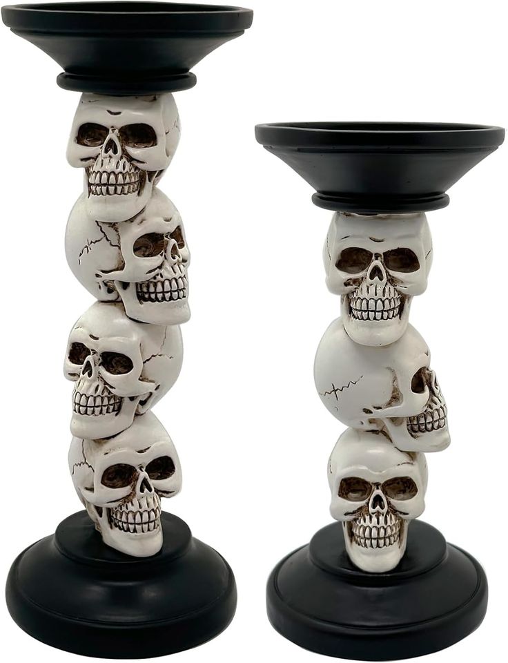 three skulls are stacked on top of each other in the shape of a candle holder