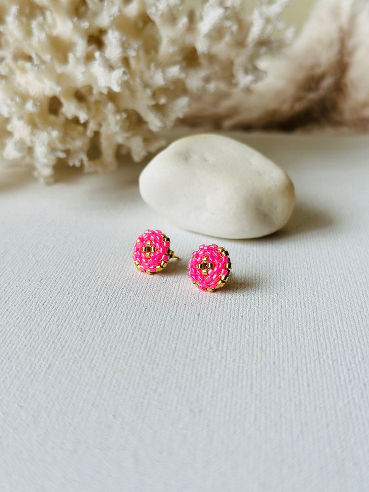 Make your everyday outfit more shiny wearing these pink/ gold beaded post earrings. These statement stud earrings are made from Miyuki Delica seed beads and supplied with stainless steel accessories. So lightweight and comfortable to wear, these dainty beaded studs would be the perfect adornment for holiday look. If you're looking for delicate seed bead earrings for special occassion, this pair is a great finding for you. Also, these minimalist earrings are making a great Christmas gift for bohe Miyuki Stud Earrings, Pink Beaded Earrings With Gold Beads As Gift, Pink Party Earrings With Tiny Beads, Pink Earrings With Gold Beads, Pink Earrings With Colorful Beads For Festive Occasions, Pink Round Earrings With Tiny Beads, Pink Earrings With Tiny Beads, Pink Festive Earrings With Colorful Beads, Pink Colorful Beaded Earrings For Festive Occasions