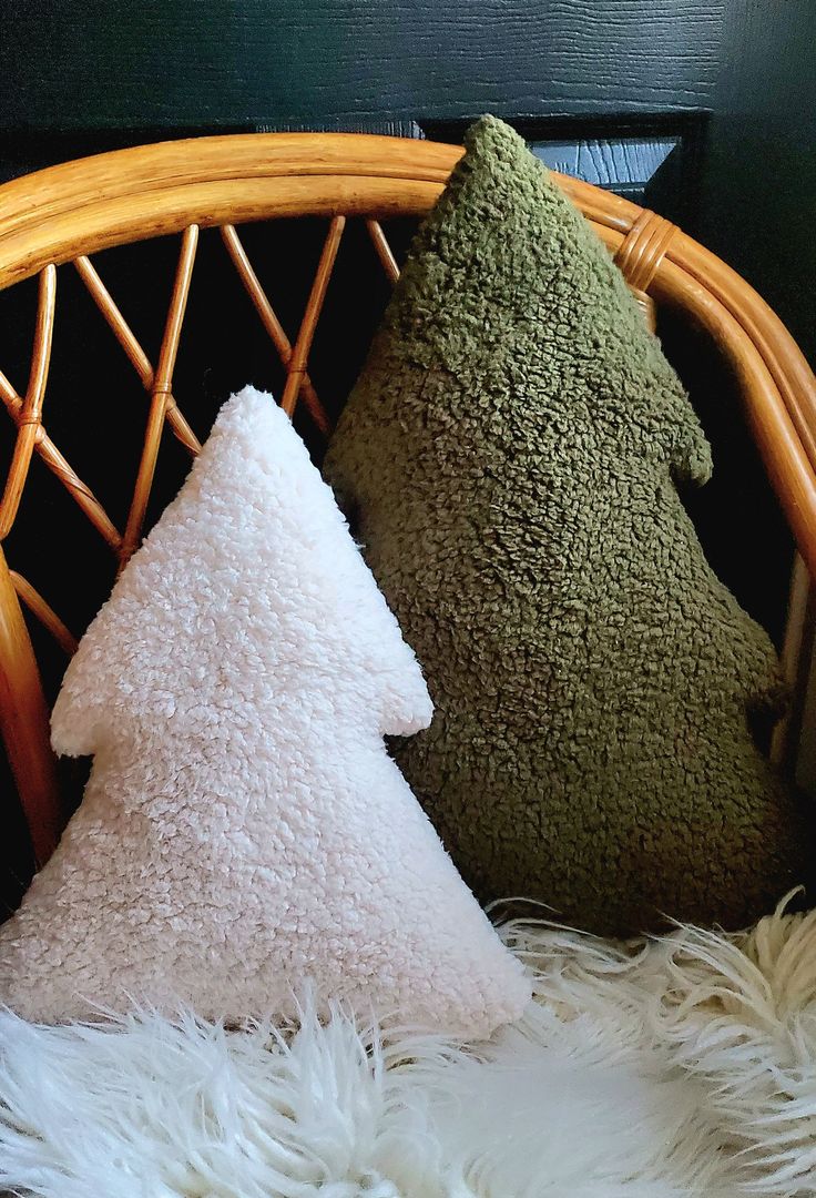 two pillows sitting next to each other on a chair