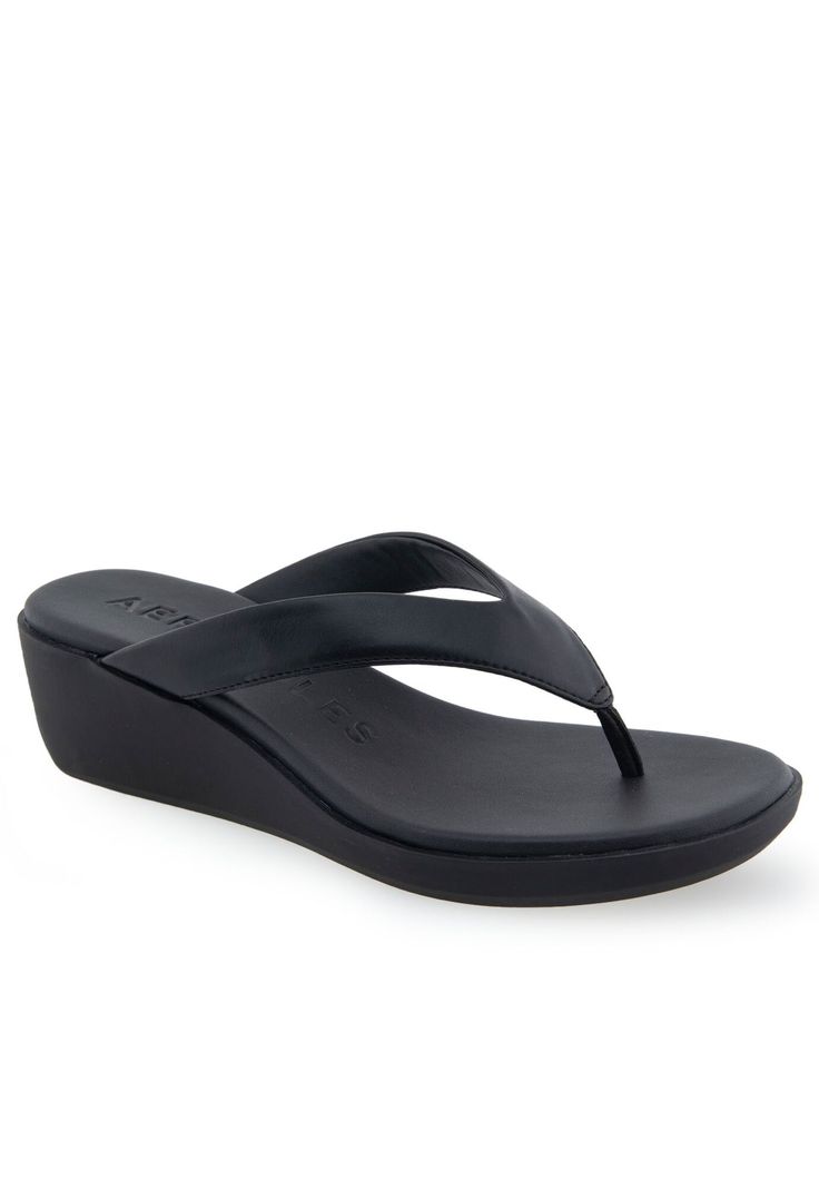 The Aerosoles Isha sandal is an exquisite piece of footwear, crafted with a sleek thong upper and a cushioned footbed inset atop a molded, lightweight unit wedge. Its refined silhouette and superior durability make this sandal perfect for special occasions and everyday wear alike. Experience the luxury of Isha today.FAUX LEATHER UpperSynthetic LiningTPR OutsoleDIAMOND FLEX OUTSOLE Footbed2" Heel heightSandal available in sizes 5-10M with half size,11M,12M | Women's Isha Sandal by Aerosoles in Bl T-strap Toe Loop Sandals With Cushioned Footbed, Toe Loop T-strap Sandals With Cushioned Footbed, Modern Slip-on Flip Flops With Removable Insole, Cushioned T-strap Synthetic Sandals, Cushioned T-strap Sandals With Single Toe, T-strap Sandals With Cushioned Footbed And Single Toe Strap, T-strap Sandals With Textured Footbed And Single Toe Strap, Synthetic T-strap Sandals With Textured Footbed, Synthetic T-strap Sandals With Cushioned Footbed