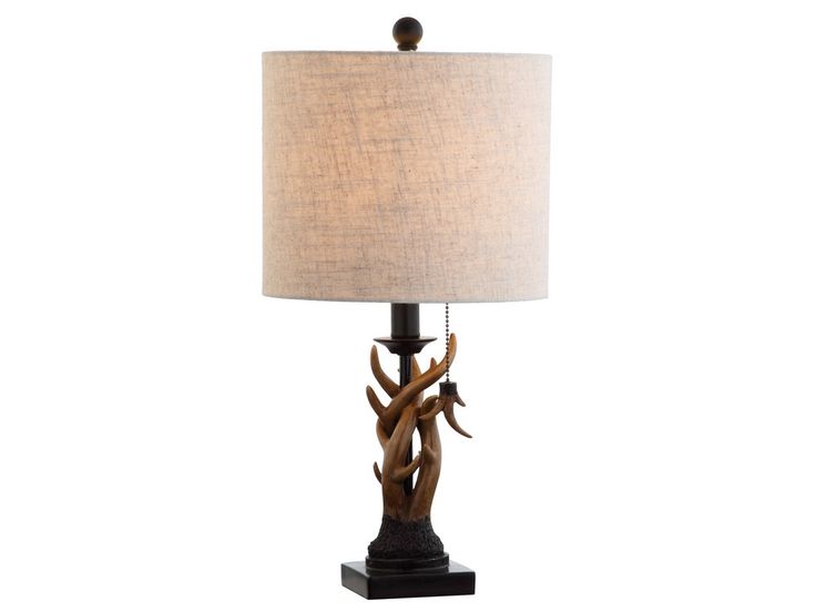 an antler lamp with a white shade on it's side and a black base