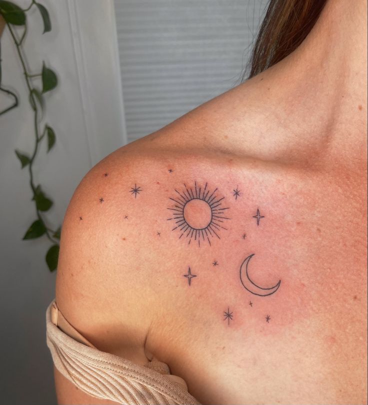 a woman's shoulder with the sun and stars on it