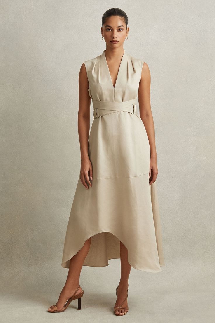 Find REISS Ava Linen Lyocell Strappy Midi Dress on Editorialist. Inspired by a corsetry aesthetic, the Ava midi dress cinches at the waist with adjustable belt straps. It's lustrous linen-lyocell fabric and tactful shoulder pleats maintain a confident look. Linen-lyocell blend. V-Neckline. Pleats to shoulder. Adjustable belt straps. Side pockets. Zip-closure to side. Dipped midi length. The model is wearing a size 8 Chic Spring V-neck Corset Dress, Spring Chic V-neck Corset Dress, Chic V-neck Corset Dress For Spring, Spring V-neck Chic Corset Dress, Elegant Dresses With Natural Waistline For Daytime, Elegant Dresses For Daywear, Sleeveless Dress With Natural Waistline For Daywear, Fitted Midi Dress With Natural Waistline For Spring, Daywear Midi Dress With Natural Waistline