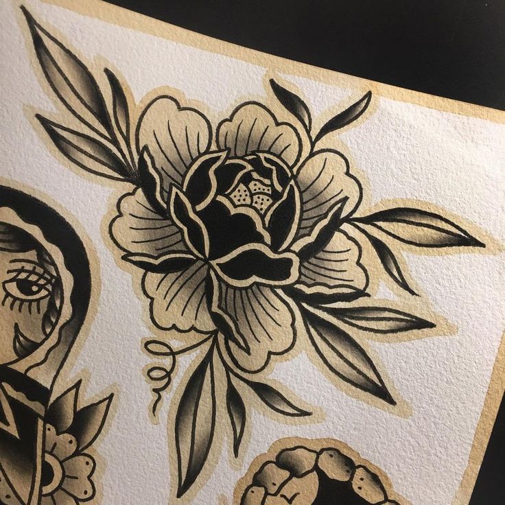 an image of some flowers and skulls on a piece of paper that has been drawn