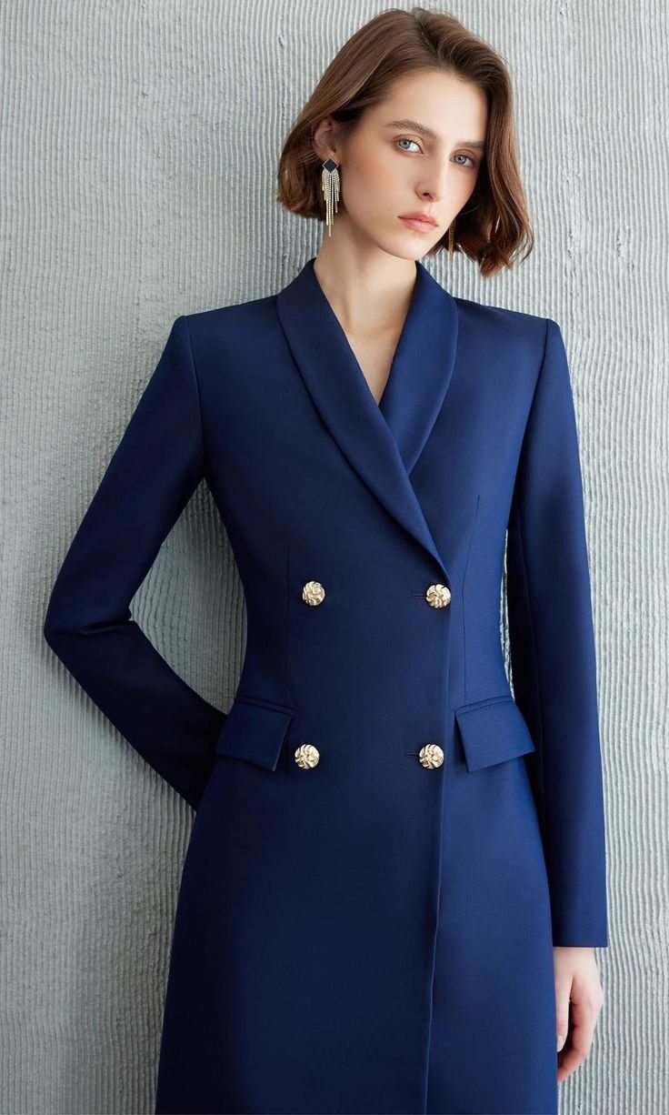 Exude Confidence with the Navy Double-Breasted Blazer Dress Step into a world of refined elegance with our Navy Double-Breasted Blazer Dress—the epitome of power dressing for the modern woman. This dress combines the sharp tailoring of a blazer with the femininity of a dress, creating a look that is both authoritative and elegant. Crafted from high-quality fabric, it features a sleek navy hue, structured shoulders, and gold-tone buttons that add a touch of luxury. The long sleeves and tailored f Elegant V-neck Blazer For Semi-formal Occasions, Elegant V-neck Semi-formal Blazer, Elegant Double-breasted Formal Suits, Elegant Double-breasted Spring Suits, Elegant Double-breasted Suits For Spring, Elegant Spring Suits With Double-breasted Button, Elegant Double-breasted Blazer For Work, Elegant Spring Suits With Double-breasted Button Fastening, Elegant Double-breasted Suit With Button Closure