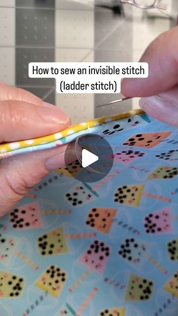 someone is using scissors to sew an invisible stitch pattern on a fabric piece in their hand