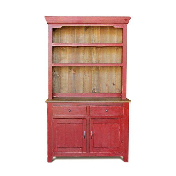 a red bookcase with two doors and drawers on the bottom shelf is against a white background