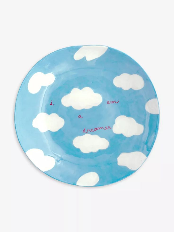 a blue plate with white clouds on it