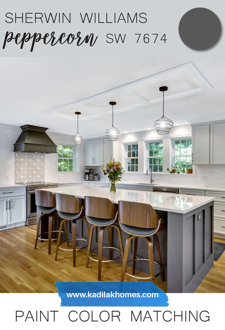 a kitchen with white cabinets and gray counter tops, painted in shewn williams's peppercorn sw774