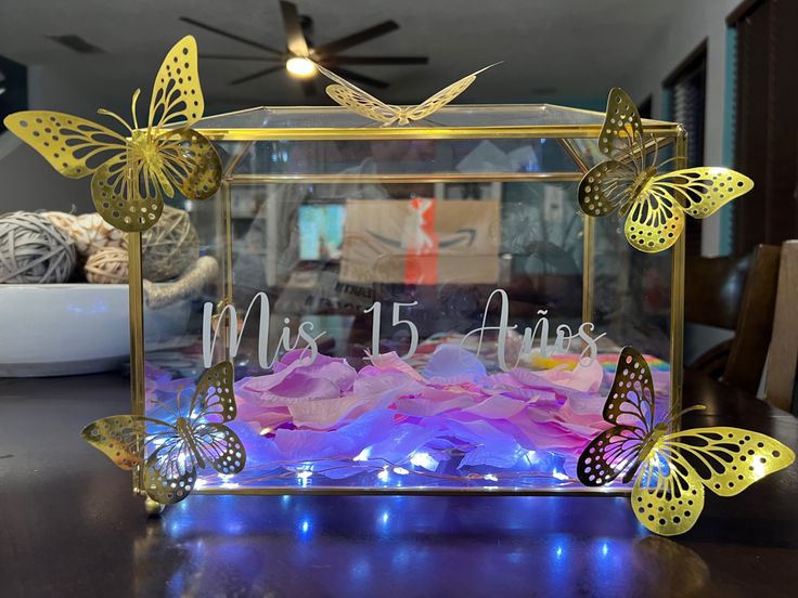 a glass box with butterflies on it and the words miss 15 flies written in white