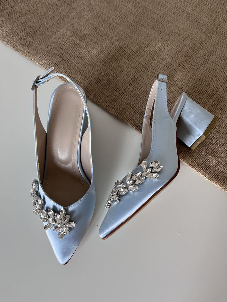 a pair of blue high heeled shoes sitting on top of a table