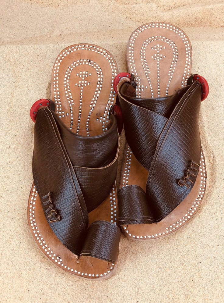 Use code COMBINEDSHIPPING and get $50 off your second pair. Check out all men's leather sandals: https://www.etsy.com/shop/sandcruisers/?section_id=25459641 You will love these traditional Arabian sandals. The straps and soles are made of leather. The leather lining will feel so soft and comfortable against your foot. They are designed to fit your foot loosely with lots of room in the toe-ring and straps. The leather sole will mold and shape to your foot over time, even creating an arch against Summer Leather Sandals, Mens Slide Sandals, Sandals For Men, Leather Sandals Handmade, Mens Leather Sandals, Brown Leather Sandals, Toe Ring, Palm Beach Sandals, Toe Rings