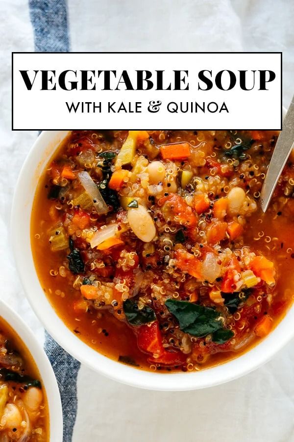 two bowls of vegetable soup with kale and quinoa in them on a white table cloth