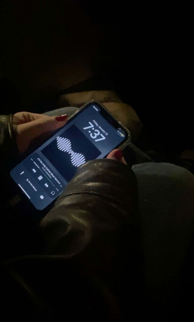 the person is using their cell phone in the dark