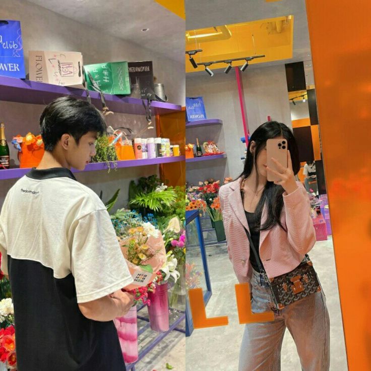 a man and woman taking pictures in a flower shop