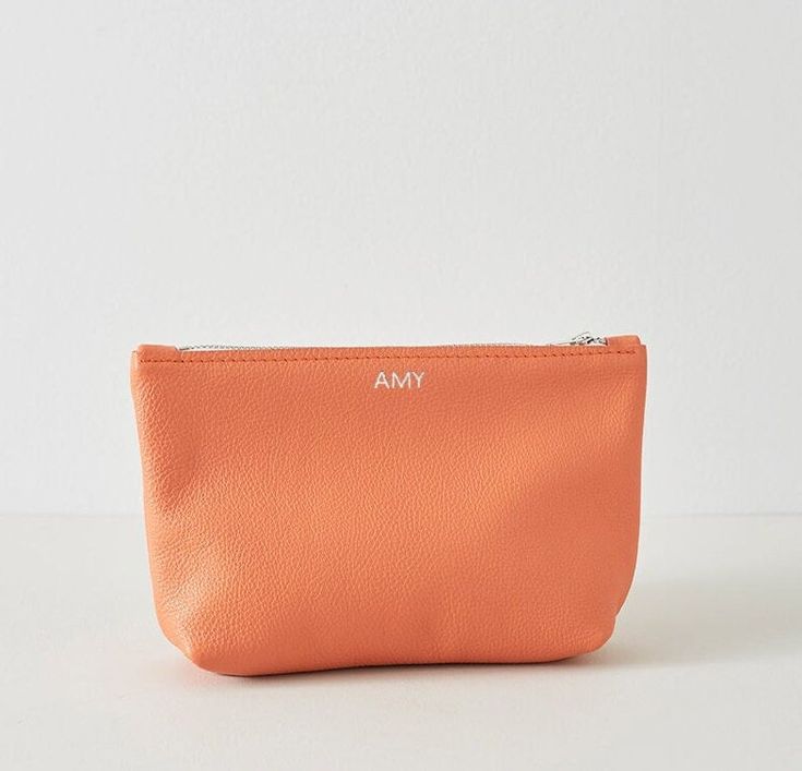 Our leather pouch is also perfect for travel and its compact size makes it easy to pack in a suitcase or carry-on bag. Handmade with a YKK Zip to ensure your belongings stay safe and secure inside, you'll be able to travel in style wherever you go! Available in a range of beautifully soft Italian leather summery colours they will bring a pop happiness into any outfit, or are the perfect gift as we offer both plain or personalised pouch options. *Product Details* * Measurements -       * Top of t Soft Leather Pouch Cosmetic Bag For Everyday Use, Soft Leather Everyday Pouch Cosmetic Bag, Soft Leather Cosmetic Pouch For Everyday Use, Rectangular Soft Leather Travel Pouch, Orange Pouch Clutch For Daily Use, Modern Compact Pouch For Gifts, Portable Pouch Travel Accessories, Modern Compact Pouch As A Gift, Modern Compact Pouch As Gift