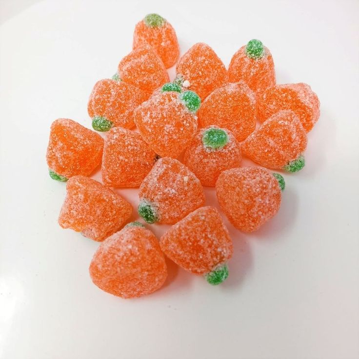 small orange candies with green leaves on them