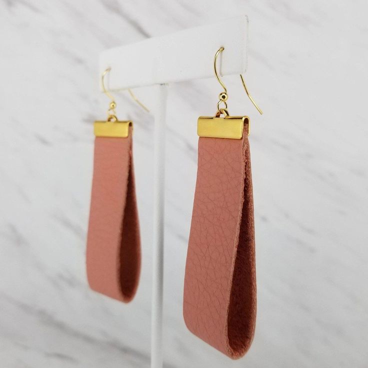 Salmon Pink Leather Large Hoop Earrings Modern, large loop earrings perfect for everyday wear! Made from genuine leather, these are lightweight and comfortable. The pair you will find yourself reaching for day after day. Length approx. 3" Feather weight Genuine leather  Gold, or silver plated  Love it, or we'll take it back! Note: all items are handcrafted from genuine leather and made to order. Please allow for minimal differences from the earrings pictured due to the handcrafting process and the natural material of the leather. Leaf Earrings Diy, Gunmetal Earrings, How To Make Leather, Navy Blue Earrings, Hoop Earrings Large, Diy Leather Earrings, Leather Jewelry Diy, Loop Earrings, Earrings Large