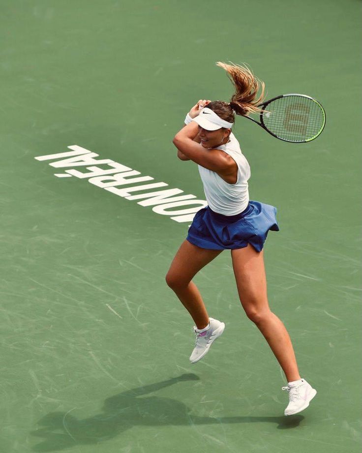 a female tennis player in action on the court