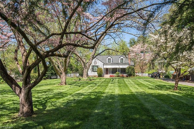 a large yard with lots of grass and trees