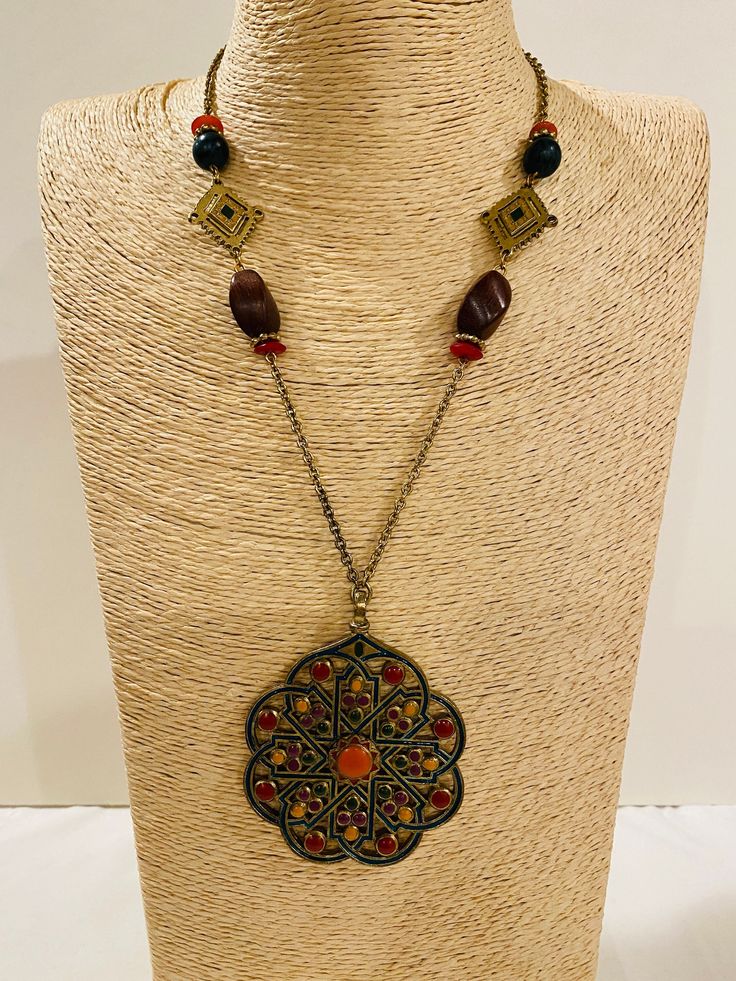 VINTAGE MOROCCAN  STYLE BOHO, dainty hippie bohemian  necklace, A fun vintage necklace made of multi color  wood beads with claps fits right over your head great , you can wear it long and can be ADJUSTED  statement piece to throw on for a bit boho chic  Very unique with lots of style for summer jewelry  great with everything you wear  26"  Chain Length,+ 3"  + 3" L  Pendants  -   $ 35.00 Great for you and for a special  gift  Please feel free to convoy me with any question. We have lots of vintage handmade jewelry, so please check out our other listing Thanks for stopping by , Have a sweet creative Healthy Day Vintage Red Necklace With Colorful Beads, Red Vintage Necklaces With 8mm Beads, Vintage Red Hand-strung Beaded Necklaces, Bohemian Multi-strand Red Beads, Vintage Brown Multi-strand Beaded Necklace, Vintage Beads Necklace, Pattern Flower, Bohemian Necklace, Hippie Bohemian