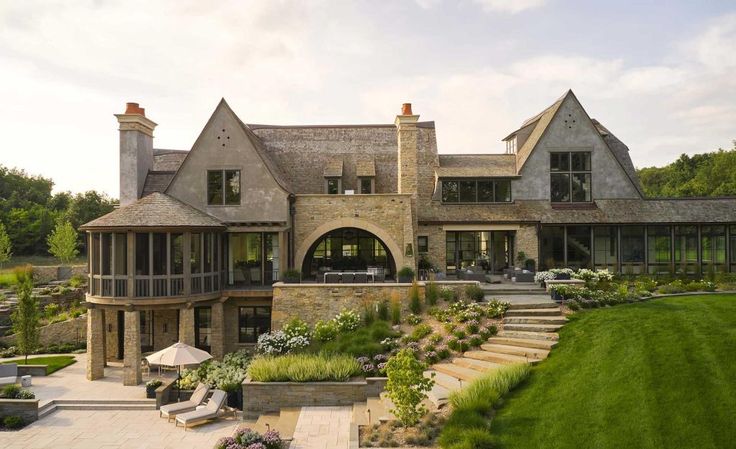 a large house with lots of windows and landscaping