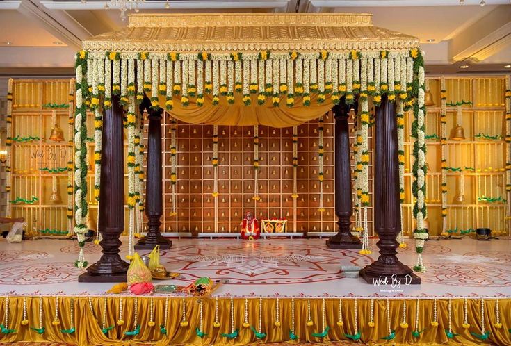 Traditional & Classy south Indian Wedding Mandap Decor with flowers and bells.. Decor @wedbyd.events Follow www.decorsutrablog.com for Ideas about Indian Wedding Decor Email your original pictures to @decorsutrablog@gmail.com to get featured. #wedmegood #weddingsutra #shaadisaga #shaadimagic #weddingz #WeddingInspiration #decoration #weddinginspo #instawedding #weddingflowers #haldiceremony #weddingreception #traditionalwedding #engagementdecor #weddingdetails #indianweddings #shaadi #dreamw Marriage Hall Decoration, Hindu Wedding Decorations, Indian Wedding Stage, Small Wedding Decor, Engagement Stage Decoration, Mandap Design, Reception Stage Decor, Simple Stage Decorations, Wedding Stage Backdrop