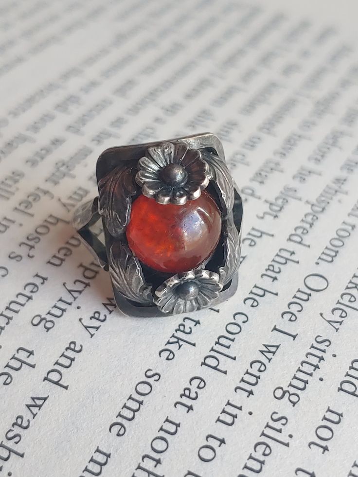 "Niels (1908-1981) first opened his shop in 1931.  He first worked silver and stone, and had many pieces reflecting nature. Wonderful Denmark modernist design. Niels Erik From amber flower ring, circa 1960s. Perfect condition, light surface wear, with the gemstone being in fantastic condition.  This is an iconic N.E. From Design. Basic info: Size- Approx. 4.75\" Color: Silver / orange Type- Silver work weight- approx. 6.2g Silver Mark- Denmark Sterling Maker Mark - N.E. From SHIPPING: All orders Modernist Sterling Silver Cabochon Jewelry, Handmade Modernist Jewelry For Collectors, Handmade Art Deco Sterling Silver Rings, Handmade Sterling Silver Art Deco Rings, Vintage Hand Forged Metal Rings, Vintage Silver Carnelian Rings, Vintage Amber Ring Jewelry, Modernist Silver Jewelry With Cabochon, Modernist Hand Forged Ring Jewelry