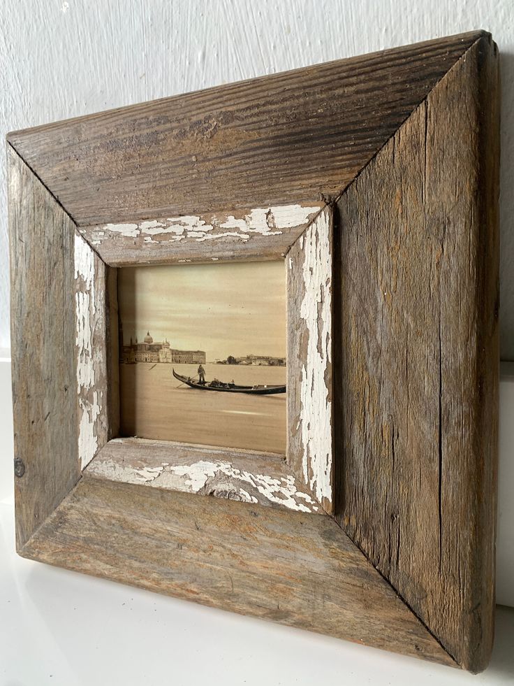 an old wooden frame with a boat in the water