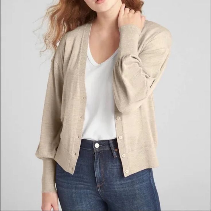 This Classic Yet Fashionable Button Down Cardigan Is Perfect For Cool Summer Night Or Fall. It Features V-Neck With Long Balloon Sleeves With Rib-Knit Cuffs, Rib-Knit Hem And Button-Front (Button Color Same As Material).Straight Silhouette With An Easy Fit That Hits At The Hip. 100% Merino Wool Color: Oatmeal Heather (Similar To Tan). Classic Gap Tops For Fall, Beige Button-up Cardigan For Everyday, Versatile Button Cardigan For Fall, Versatile Fall Cardigan With Buttons, Versatile Buttoned Cardigan For Fall, Gap Everyday Outerwear With Button Closure, Classic Everyday Outerwear By Gap, Classic Everyday Gap Outerwear, Classic Gap Outerwear For Everyday