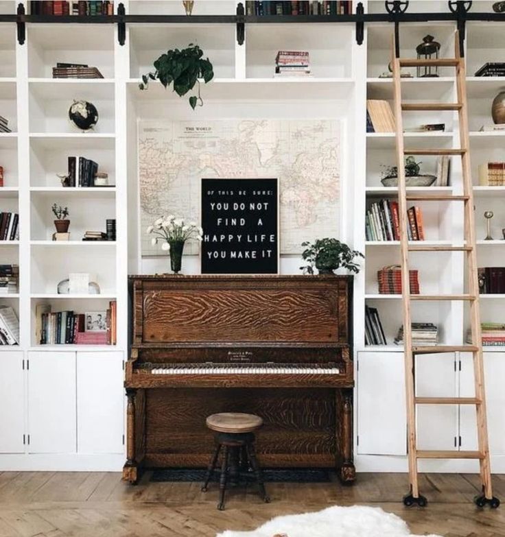 a living room filled with furniture and bookshelves next to a white bookcase