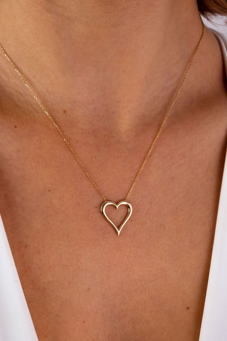 A 14K gold open heart necklace is a beautiful and meaningful piece of jewelry that is perfect for any occasion. The heart pendant is delicately crafted in the shape of an open heart, symbolizing love, compassion, and acceptance. This heart outline necklace is a charming and stylish accessory that is perfect for everyday wear or for special occasions such as Christmas, Father's Day, Mother's Day, Valentine's Day, anniversaries, and birthdays. The love charm choker is a dainty and feminine necklac 14k Gold Open Heart Necklace For Gift, Dainty 14k Gold Open Heart Necklace, Valentine's Day Fine Jewelry Open Heart Necklace, Everyday Heart Beads Open Heart Necklace, Fine Jewelry Heart Pendant Necklace For Anniversary, Fine Jewelry With Delicate Chain And Open Heart, Fine Jewelry With Delicate Open Heart Chain, Dainty Yellow Gold Jewelry With Heart Detail, Delicate Open Heart 14k Gold Jewelry