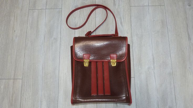 Retro leather shoulder bag, in brown and red color. Produced in 1980, the bag has three internal compartments - one large main compartment and two smaller ones. Used but in very good condition, no tears or missing or damaged parts. Suitable for carrying books, documents, a tablet or a small laptop. Approximate sizes:  Length: 27 cm (10.6 in.) Width: 9 cm (3.5 in.) Height: 33 cm (13 in.) Weight: 753 grams All photos are real. You buy what see on the photos We only offer vintage items that almost always have some type of wear and tear such as scratches, cracks, missing paint, corrosion and more. These imperfections only add style to the retro appeal. We always try to describe and show pictures of any damage or wear. Please review the photos carefully as part of the product description. Your Brown Crossbody Shoulder Bag For School, Retro School Shoulder Bag, Rectangular Brown Student Bag, Brown Satchel Shoulder Bag For School, Brown Rectangular Shoulder Bag For School, Brown Tote Shoulder Bag For School, Rectangular Brown Shoulder Bag For School, Vintage Leather Backpack-style Shoulder Bag, Vintage Crossbody Shoulder Bag For School