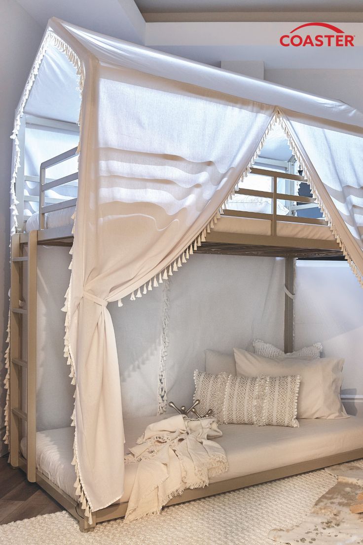 a bunk bed with white curtains and pillows