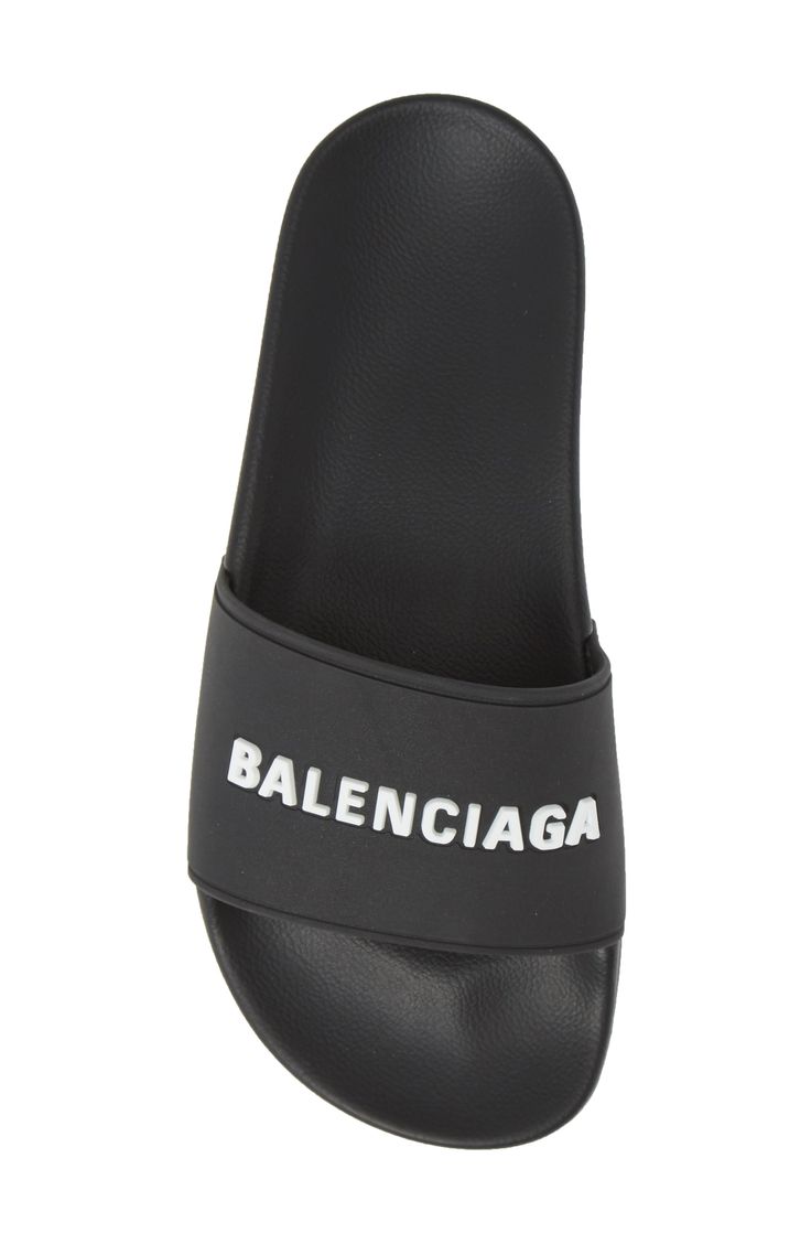 Welded logotype pops in texture and dimension from the bridge of an inky black sport slide molded with a contoured, comfortable footbed. Style Name:Balenciaga Logo Sport Slide (Women). Style Number: 5793907. Available in stores. Black Modern Slip-on Slides, Textured Sole Slides For Streetwear, Comfortable Slides With Textured Sole For Streetwear, Classic Black Slides With Textured Footbed, Modern Slides With Branded Insole For Streetwear, Modern Synthetic Slides For Streetwear, Sporty Slides With Textured Sole For Streetwear, Modern Slides With Textured Sole, Modern Slides With Rubber Sole For Streetwear