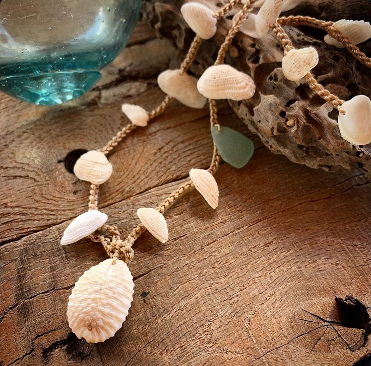 These Hawaiian ark shells look like tiny angel wings. They have been gathered from Hawaii's longest white sand beach which is known as Papohaku. This beach has a dangerous shore break that leaves these shells embedded with sand. It is also very windy most of the time so the shells usually get blown back into the ocean. Conditions must be perfect for me to find these gems.  They have been carefully drilled and crocheted with nylon cord for strength. I have added some seafoam seaglass and a bumpy cowrie for the closure. You can wear this wrap 4 times around your wrist, three times around your ankle or once or twice around your neck. When wearing as a bracelet simply wrap it around, pull the anchor shell thru the hoop, pull tight and tuck the anchor shell under one of the strands.  This one m Hand Wrapped Shell Jewelry, Beach Shell Necklace Wire Wrapped, Handmade Bohemian Sand-colored Jewelry, Adjustable Shell Coastal Jewelry, Adjustable Coastal Shell Jewelry, Adjustable Bohemian Sand-colored Jewelry, Adjustable Shell Shaped Coastal Jewelry, Adjustable Sand-colored Bohemian Jewelry, Beach Wire Wrapped Shell