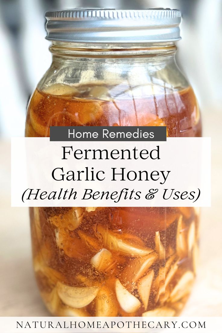 a jar filled with garlic and honey sitting on top of a table