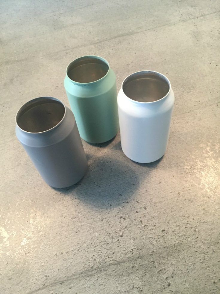 three different colored cups sitting on top of a table