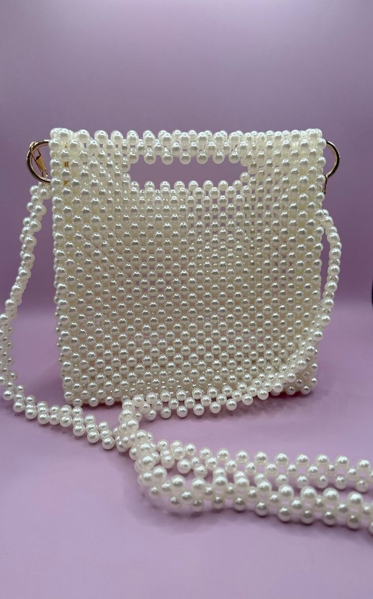 Handmade bead bag in ivory pearl with a gold accent🤍🕊️ All handbags are unique in design and color. Custom requests accepted with 3 months lead-time.  Satisfaction guaranteed.  Returns and exchanges accepted within 21 days of delivery. Bead Bag, Ivory Pearl, Gold Accent, Beaded Bags, Handmade Beads, 21 Days, Lead Time, Clutch Handbag, In Design