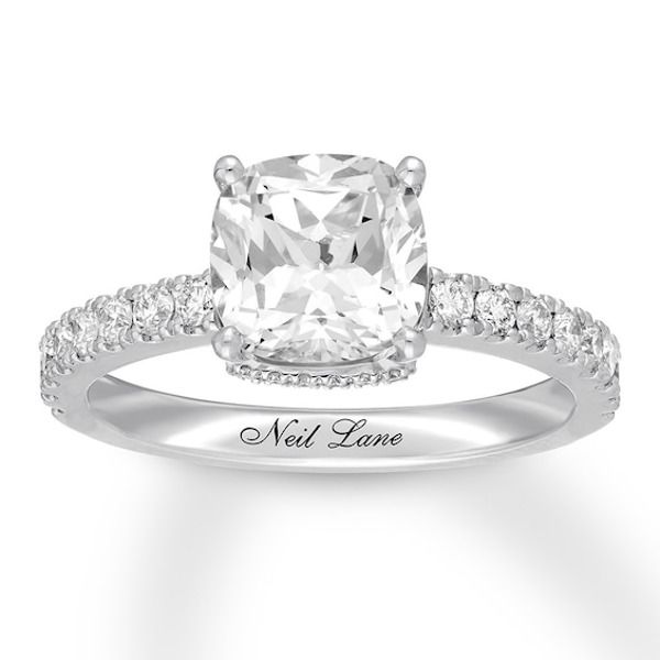 a cushion cut diamond engagement ring with pave set shoulders