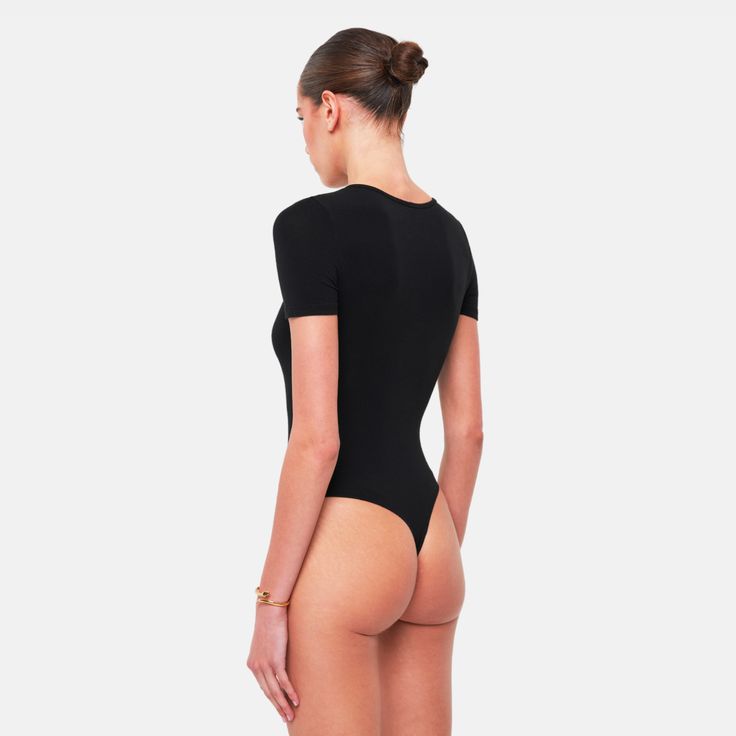 The ROSA Bodysuit is the perfect basic, crafted from an ultra-soft fabric blend that hugs your body flawlessly. Designed for both comfort and style, this bodysuit provides a sleek, form-fitting silhouette, making it an essential piece for any wardrobe.Size and fit:• The bodysuit runs small; we suggest sizing upInfo:• 48% cotton, 48% modal, 4% spandex• Gusset hook and eye closure with thong back• Machine wash (mild detergent, iron, no bleaching, dry flat, do not tumble dry)Model info:• 5' 10"/177 Back Machine, Arm Sleeve, Hug You, Black Bodysuit, Soft Fabric, Soft Fabrics, Sleek, Spandex, Wardrobe