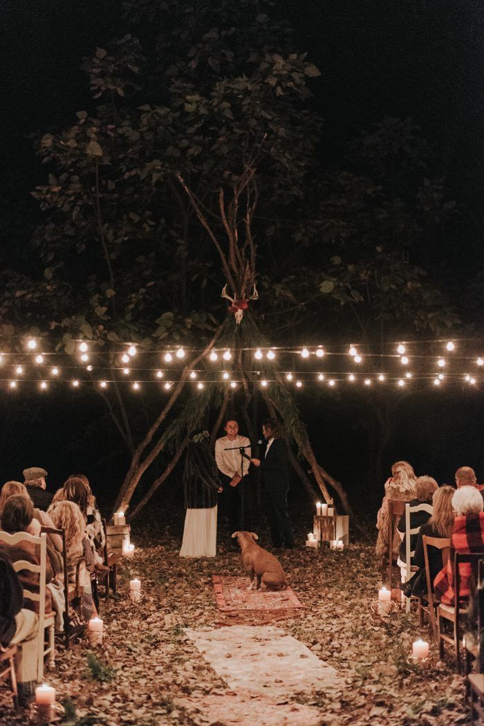 an outdoor ceremony with candles and lights