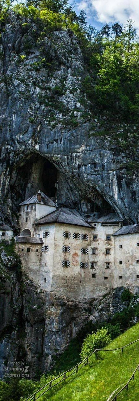 an old castle built into the side of a mountain