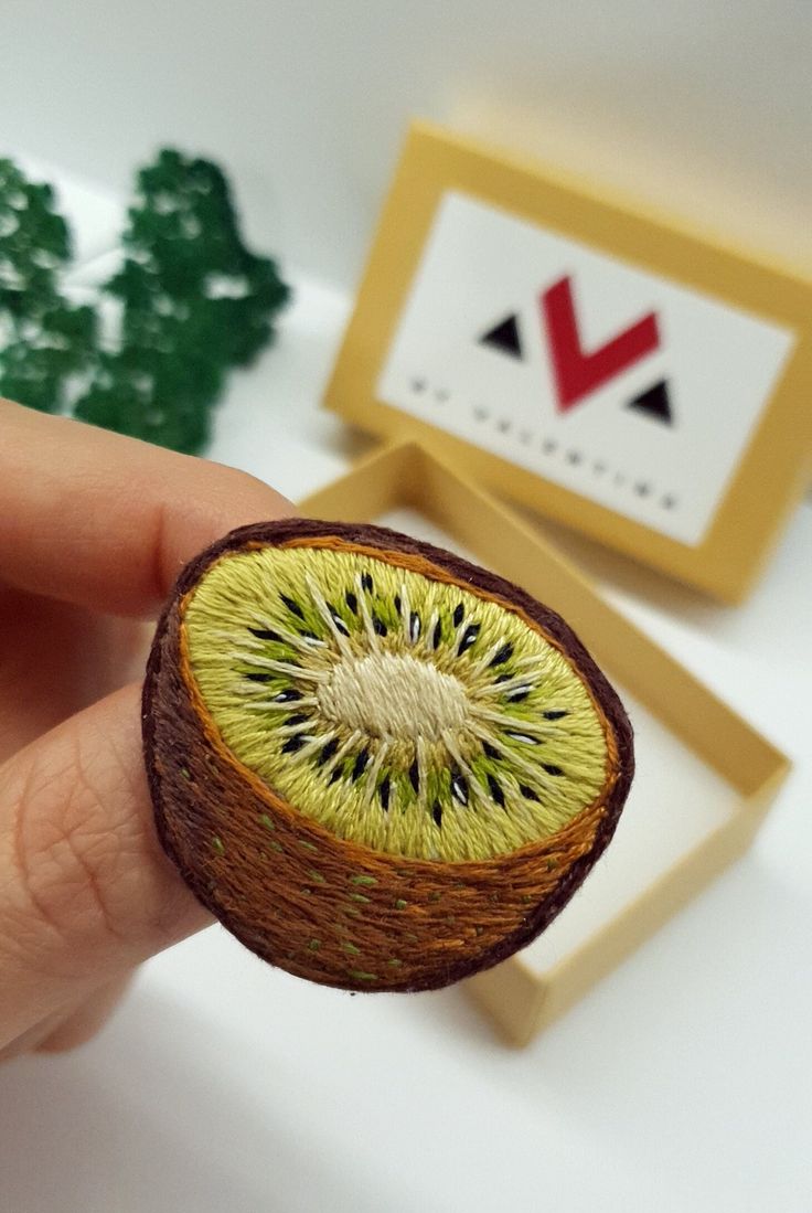 a kiwi fruit cut in half sitting on top of a table next to a box