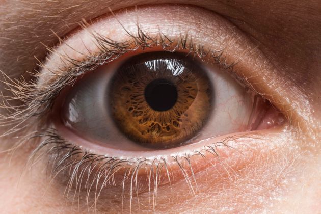 an extreme close up shot of a person's eye with the iris partially closed