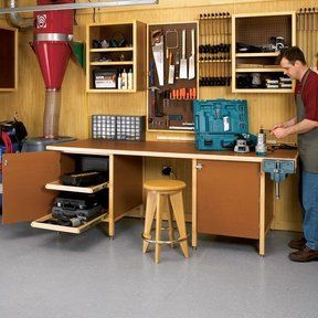 a man standing in front of a workbench